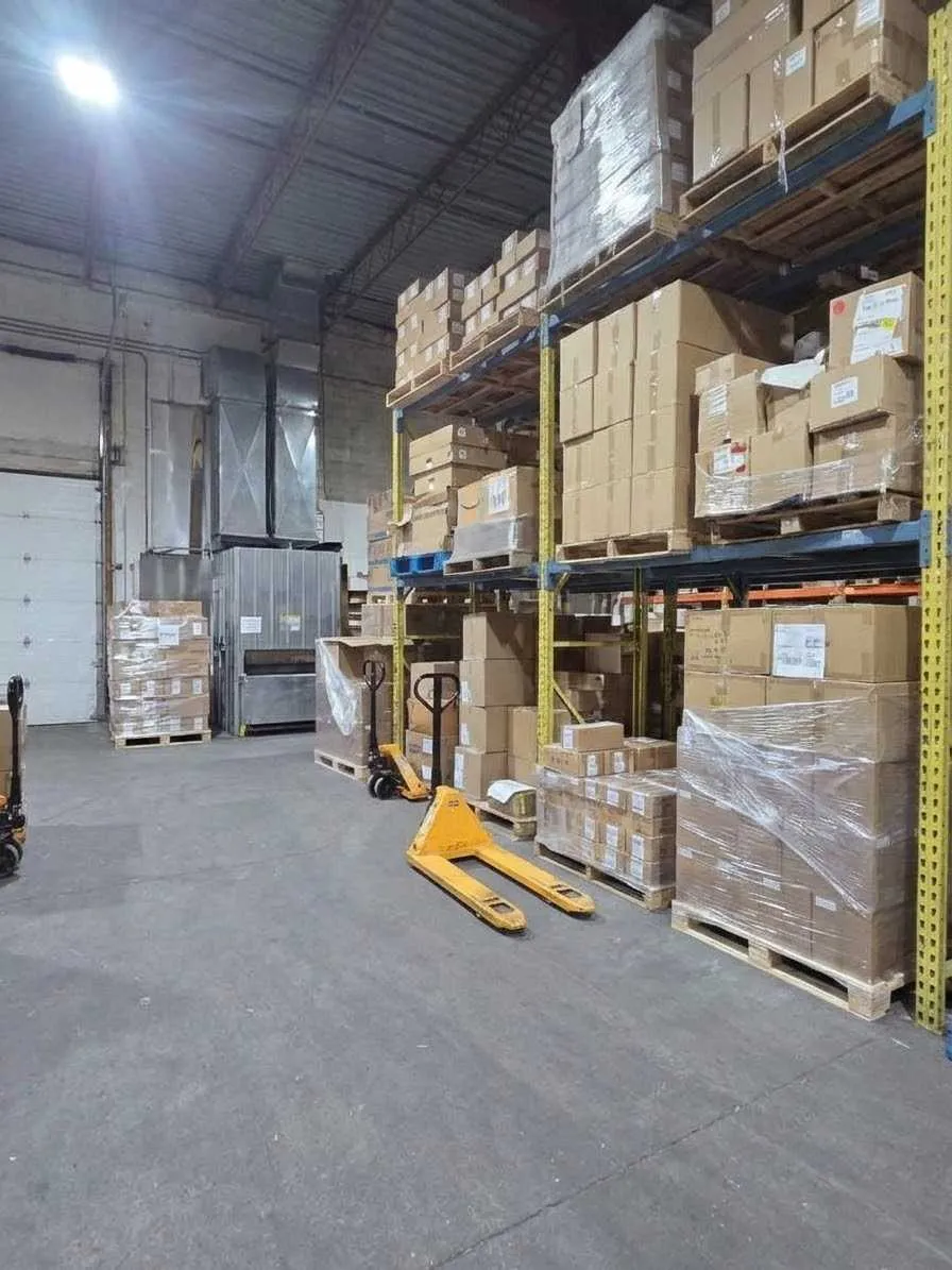 Racked pallets and pallet jacks on the RedHat Prep warehouse floor